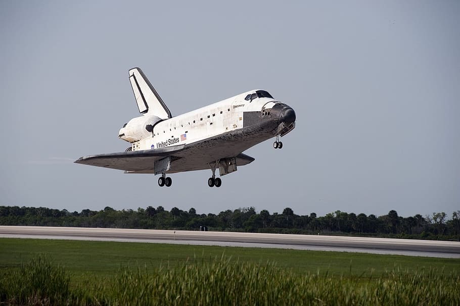 photo of white and black NASA spacecraft under blue sky at daytime HD wallpaper
