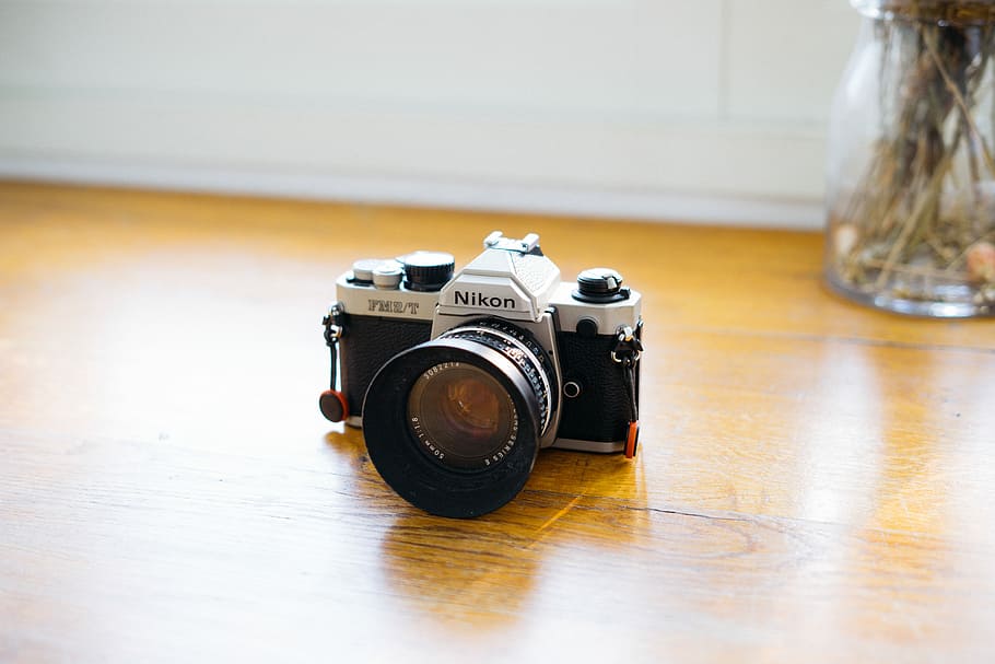 gray and black Nikon DSLR camera, black and silver Nikon SLR camera on table HD wallpaper