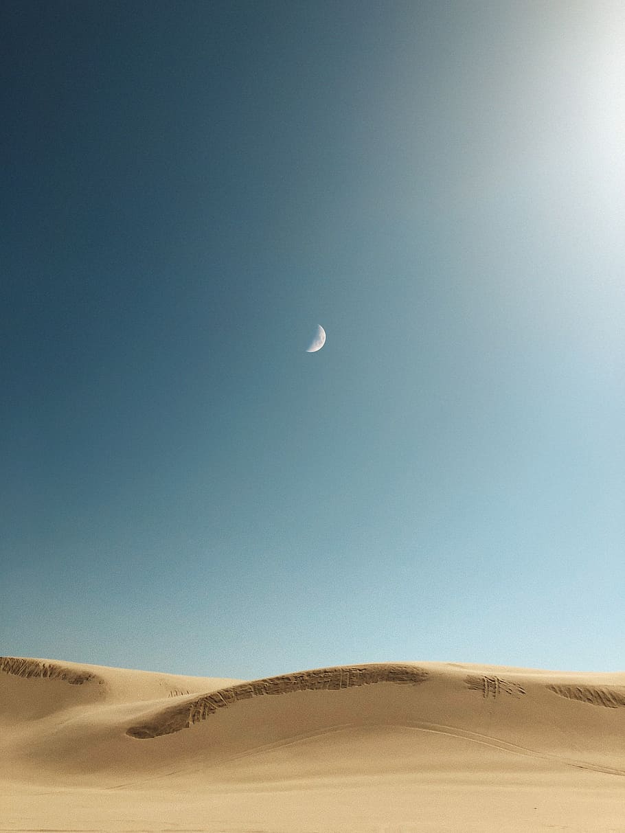 sand dunes, crescent moon photo in desert during daytime, landscape