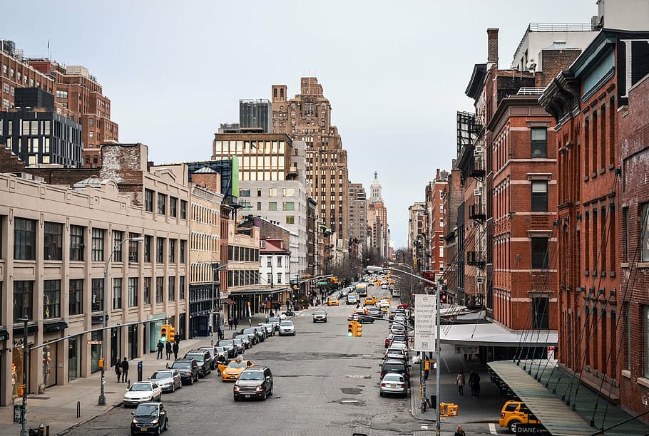 brown and beige concrete buildings between cars on street, new york