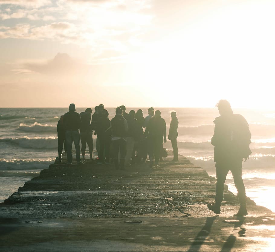photo of group of people stand on bride during daytime, men, sunset HD wallpaper