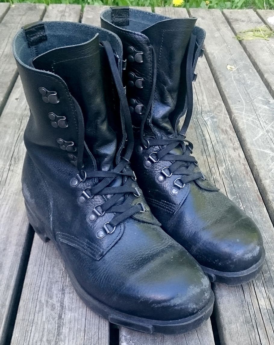 pair of black leather work boots on brown surface, army boots