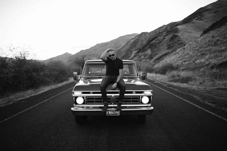 man sitting on classic truck hood, black and white, car, road, HD wallpaper