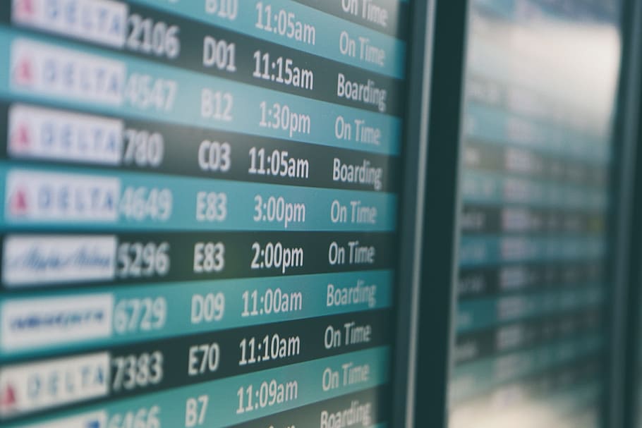 selective focus photography of plane flight schedule board, airport