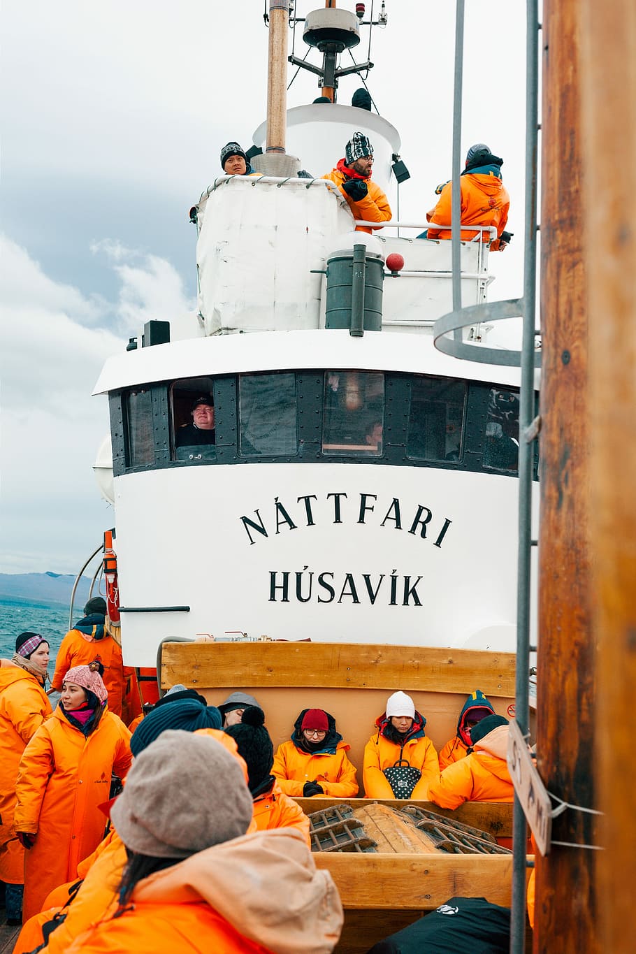 people on white Nattfari Husavik ship on body of water during cloudy weather, white Nattfari Husavik boat HD wallpaper