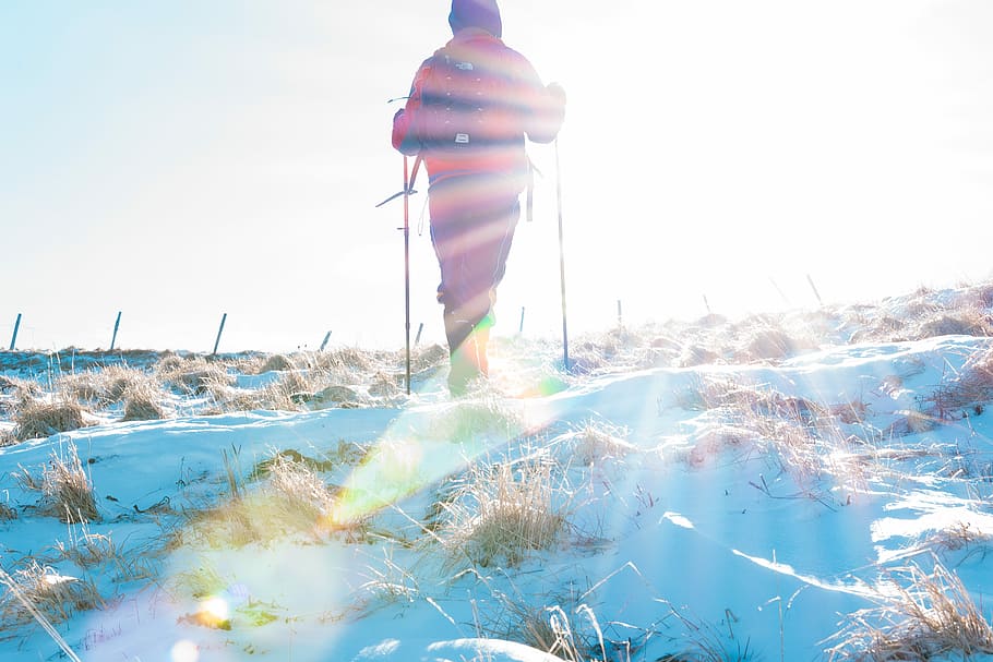 man standing on snowfield, mountain, grass, person, one person HD wallpaper