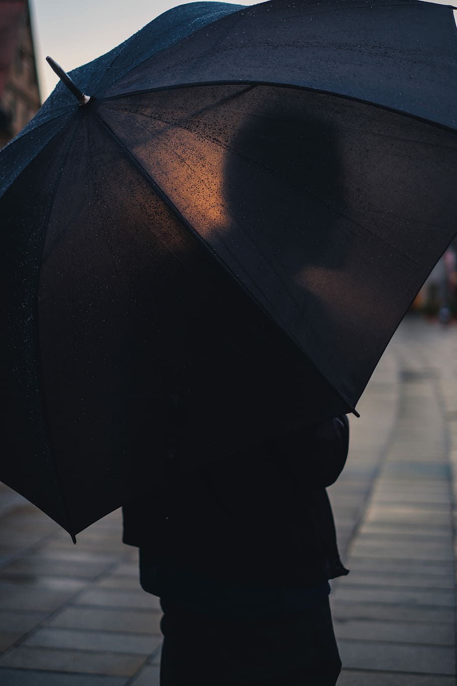 person holding black umbrella, person carrying umbrella on gray sidewalk HD wallpaper