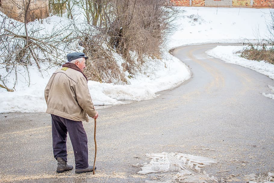 man in brown jacket in walking gesture during winter season, grandpa