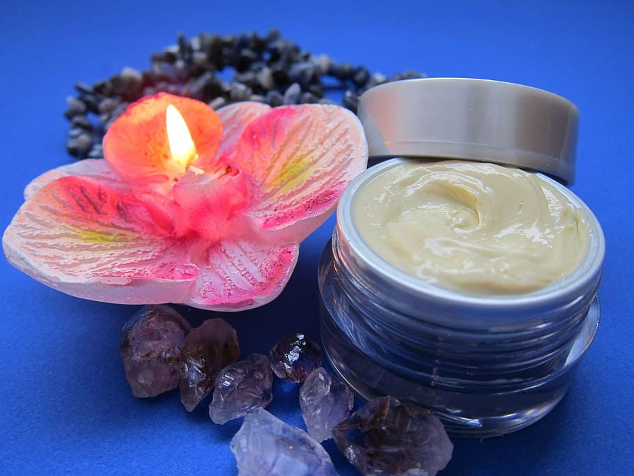 pink lighted flower candle beside cream, skin care, luxury, skincare