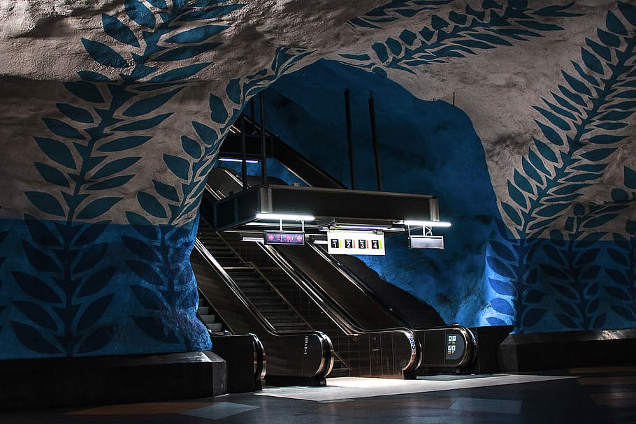 brown escalators with black bar lamp, gray escalator under the cave HD wallpaper