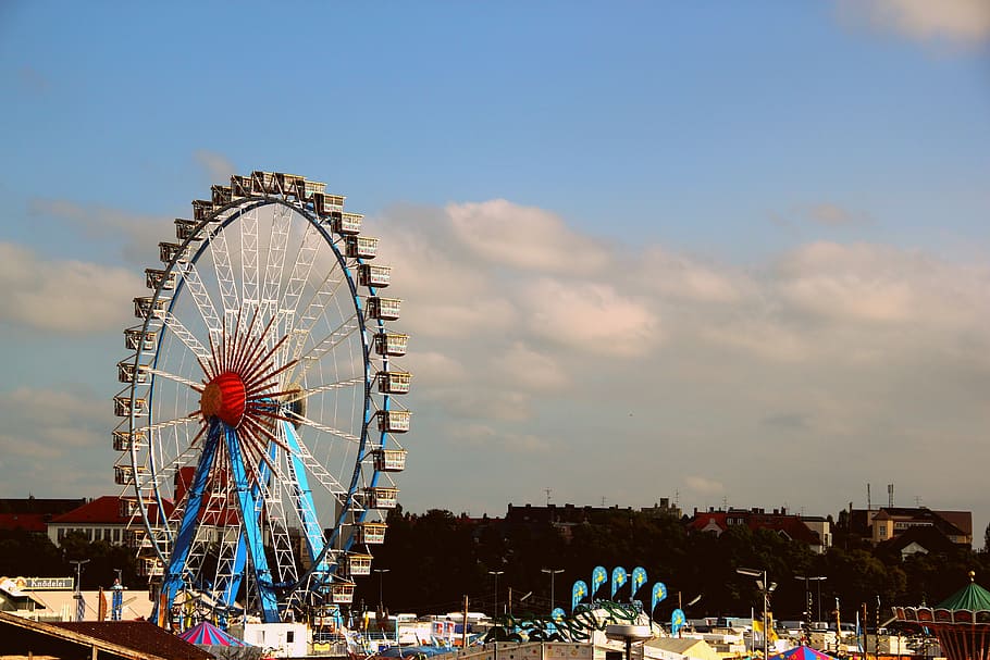 brown and blue ferris wheel under white cloudy sky during daytime