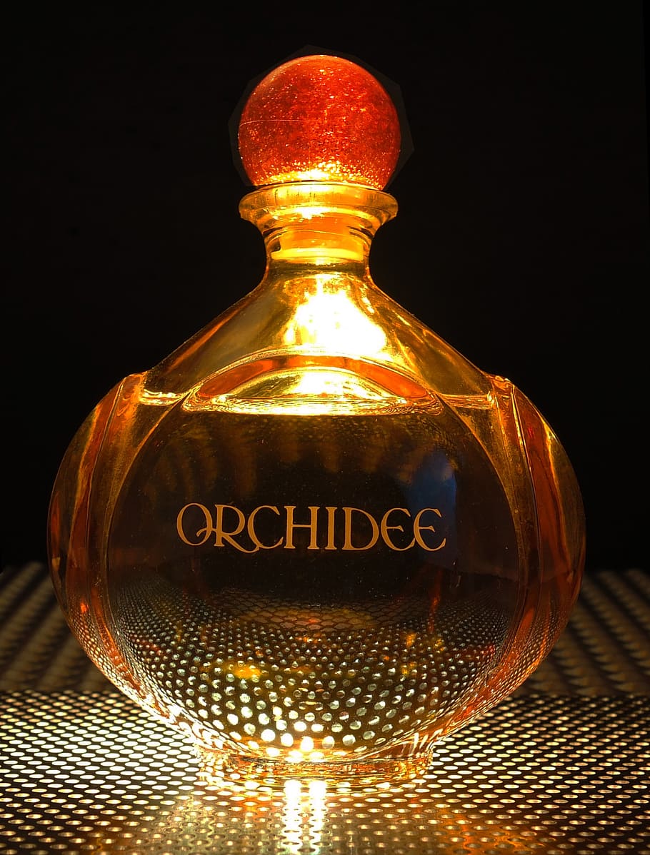 orange Orchidee glass fragrance bottle, perfume, light from below HD wallpaper