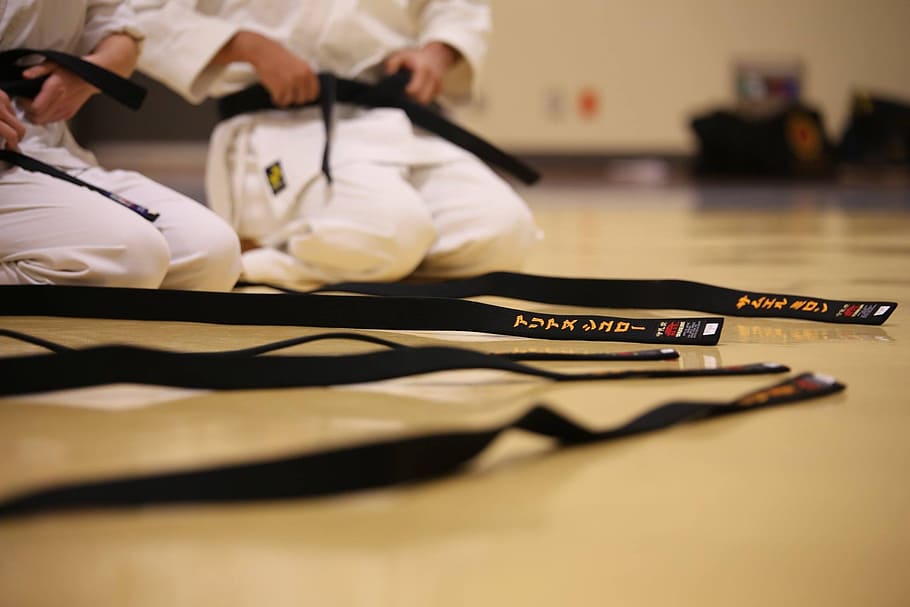 shallow focus photography GI bely, black belt, karate, traditional