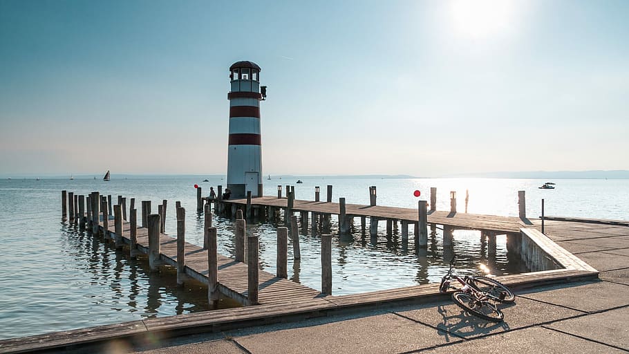 light tower on sea, lighthouse, pier, jetty, water, sky, architecture HD wallpaper