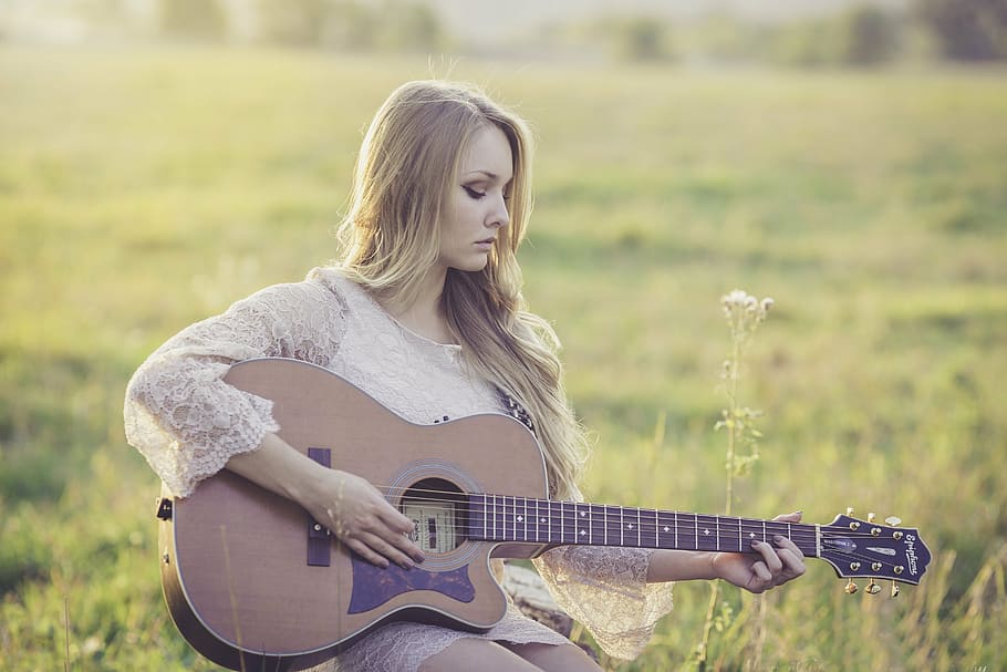 shallow focus photography of woman playing cutaway acoustic guitar, HD wallpaper