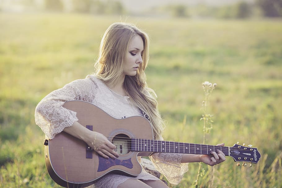Woman Playing Brown Wooden Acoustic Guitar during Daytime, countryside