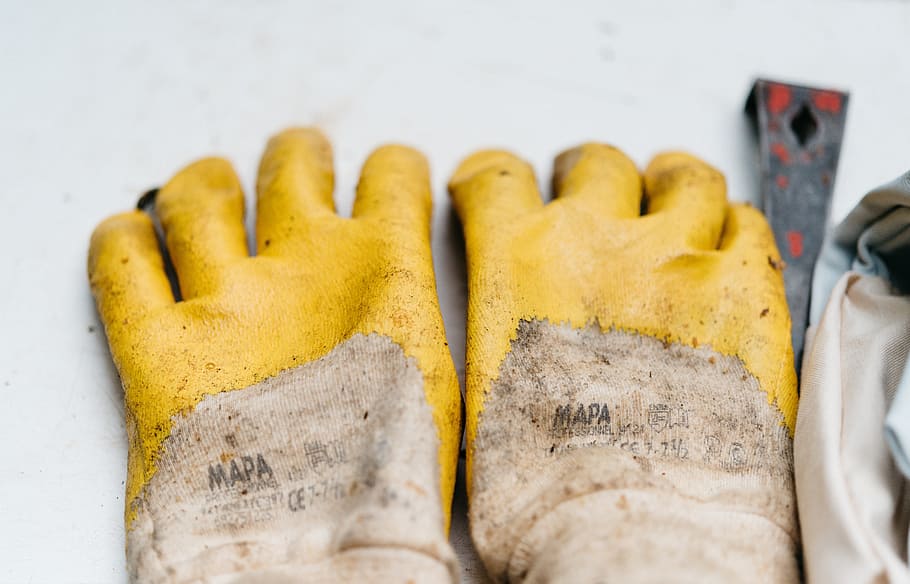 pair of brown-and-yellow leather gloves, pair of yellow-and-brown Mapa gloves HD wallpaper