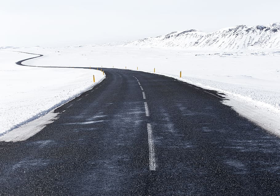 landscape photography of mountains with snow, black asphalt road along snow at daytime HD wallpaper