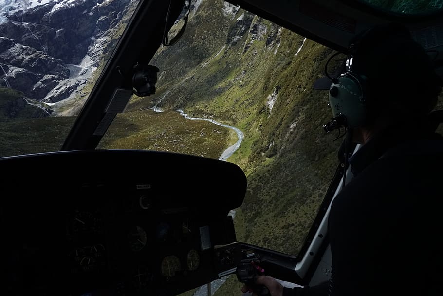 photo of black helicopter interior, pilot on control panel, remote HD wallpaper
