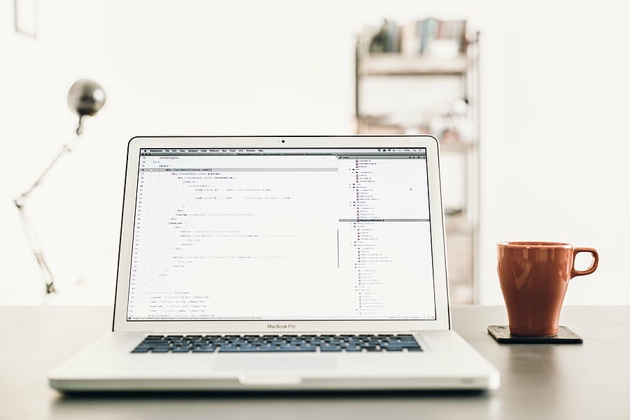 turned-on MacBook Pro on brown desk beside brown mug, laptop HD wallpaper