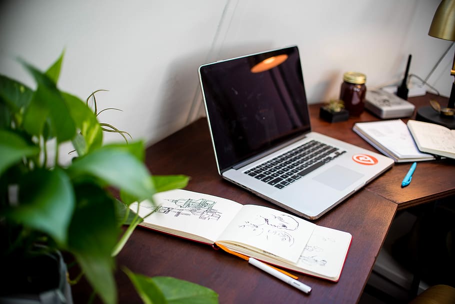black and gray laptop computer beside opened sketch book, silver laptop on desk HD wallpaper