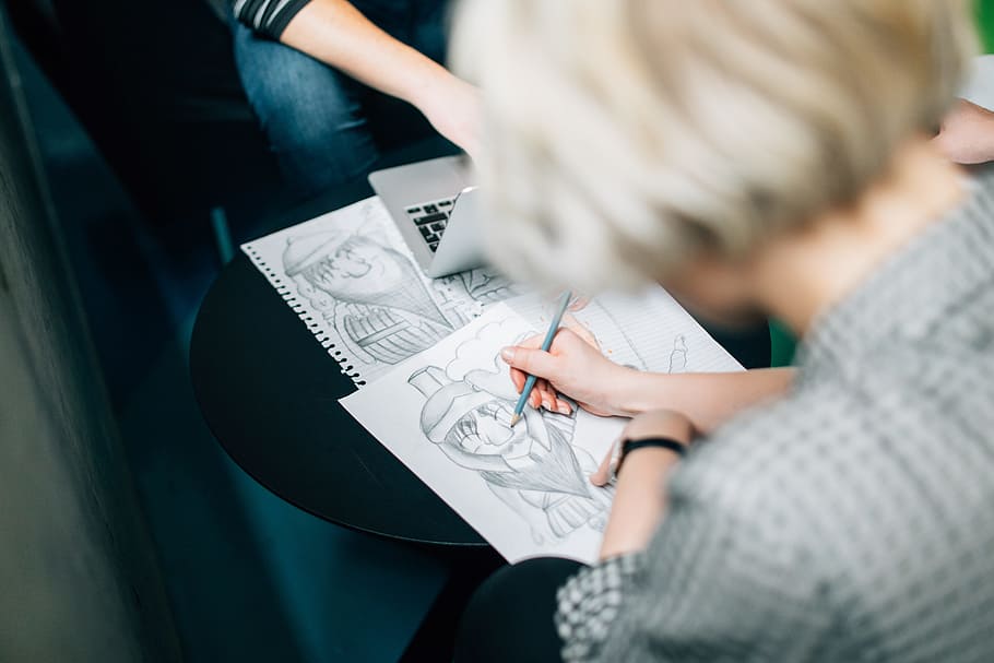 person wearing gray shirt sketch, woman in gray top holding blue pencil while drawing on white paper HD wallpaper