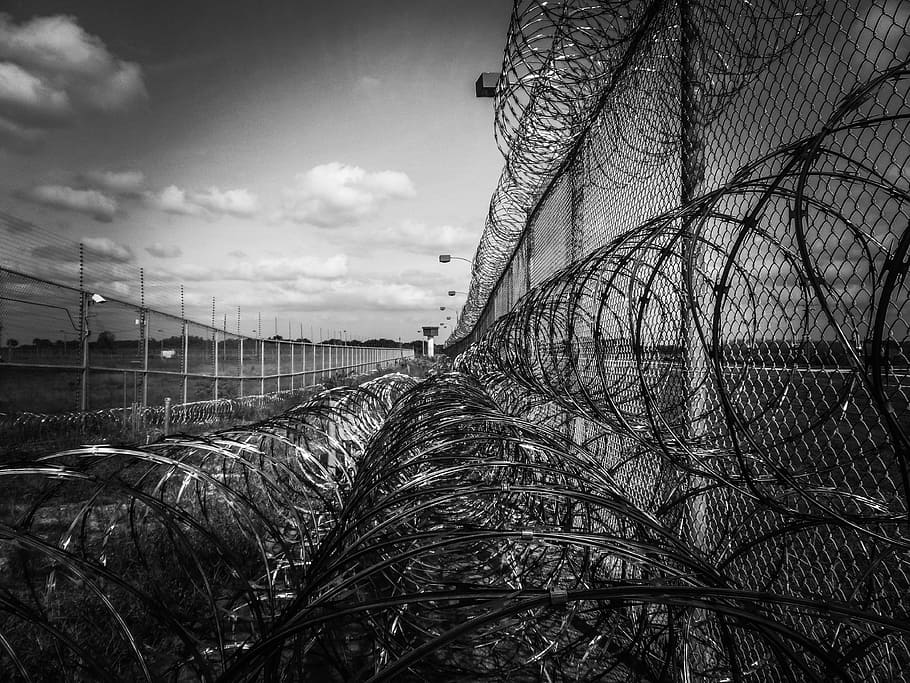 grayscale cyclone wire fence, prison fence, razor ribbon, metal
