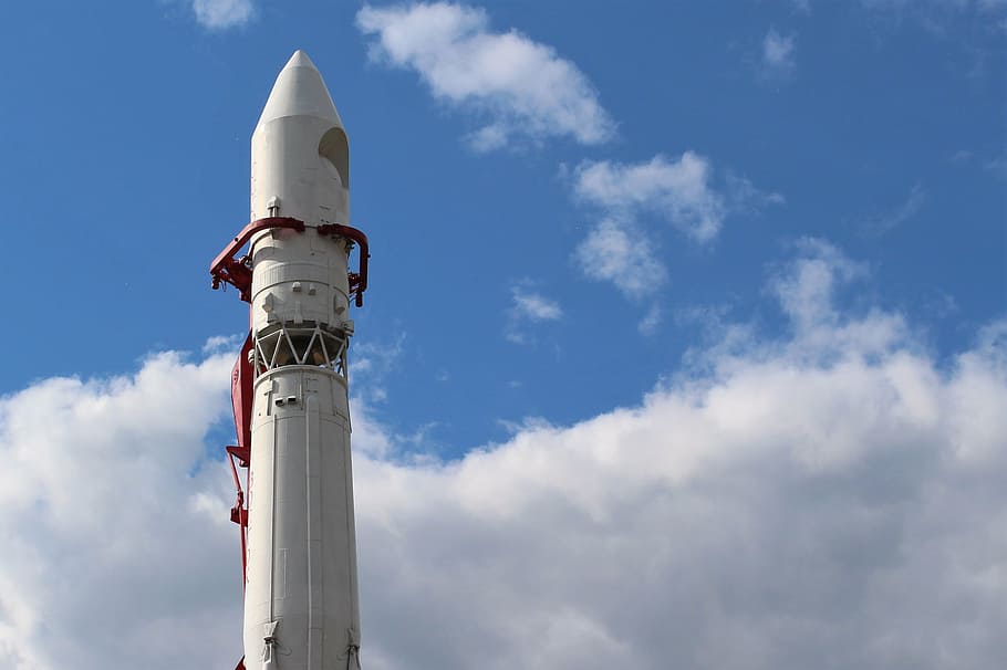 white rocket ship under cloudy sky, companion, cosmos, launch