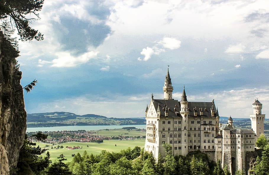 bird's-eye view of white concrete castle beside green trees under cloudy sky HD wallpaper