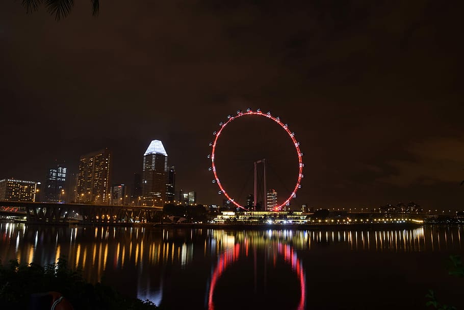 panorama photo of buildings beside ferris wheel during night time HD wallpaper