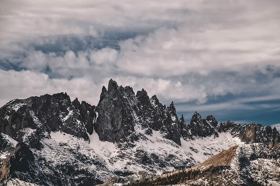 mountain range under white clouds, mountain covered with snow during daytime HD wallpaper