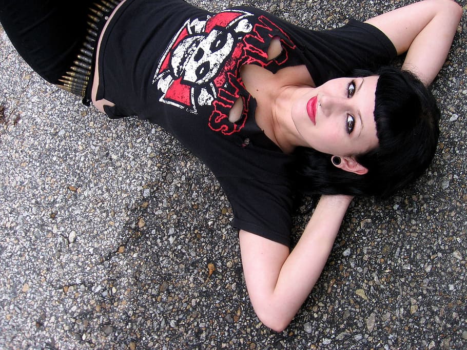 woman in black shirt lying on asphalt road, model, fashionista