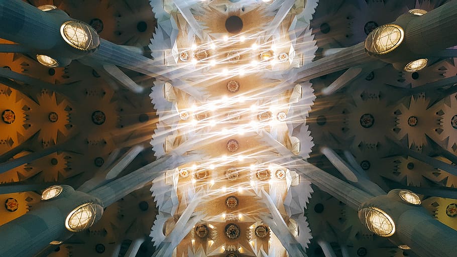 Bright lights at the ceiling of Sagrada Família cathedral in Barcelona, abstract painting in shallow focus HD wallpaper