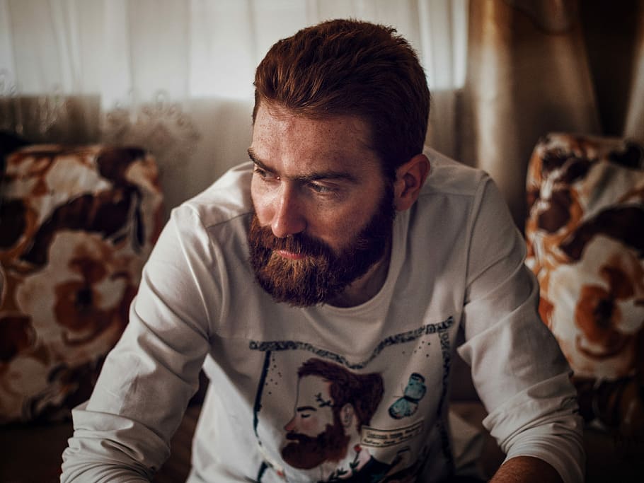 man in white long-sleeved shirt near white curtain, man wearing white shirt sitting on sofa looking sideways HD wallpaper