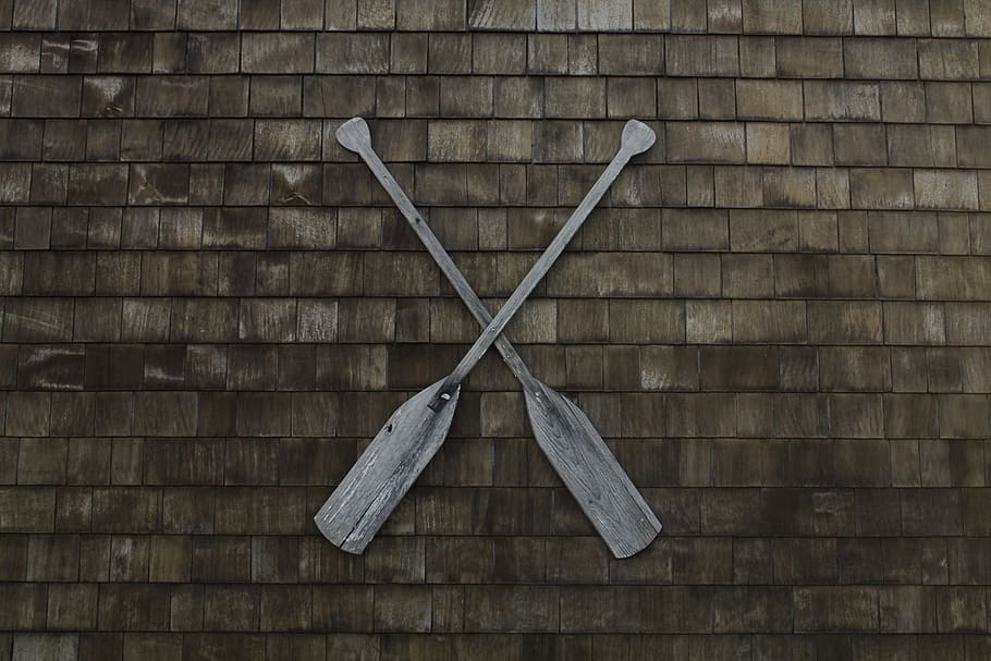 two gray wooden boat paddles hanged on wall, two brown wooden boat paddles on brown brick wall HD wallpaper