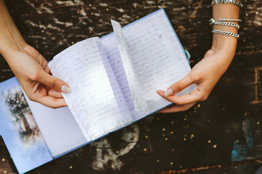 Woman reading a diary by the table, book, notebook, hands, memories HD wallpaper