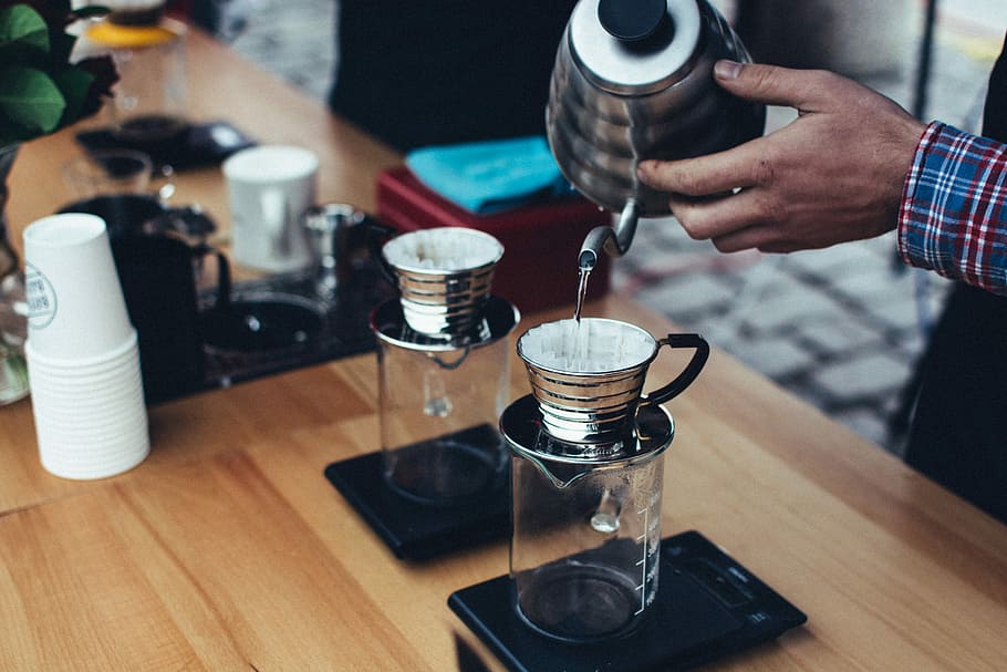 person holding gray stainless steel kettle, person pouring water into mug HD wallpaper