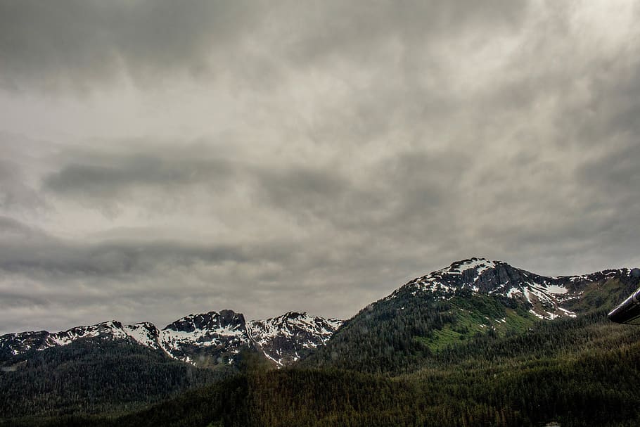 snow-covered mountains during cloudy day, bird's-eye view photography of mountain range HD wallpaper