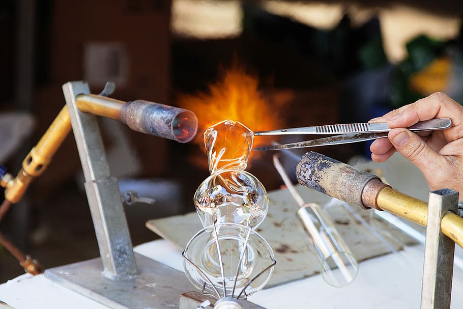 person molding glass vase through blowtorch, clear gemstone, flame HD wallpaper