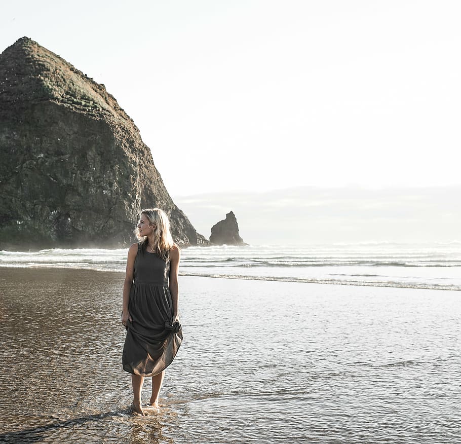 woman in gray dress standing on beach, photo, brown, sleeveless