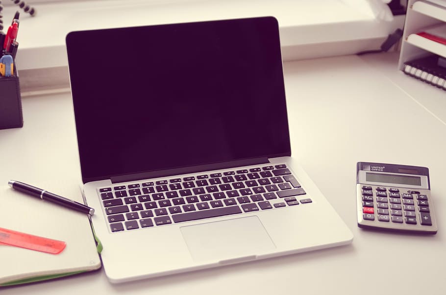 turned off laptop computer beside desk calculator, keyboard HD wallpaper