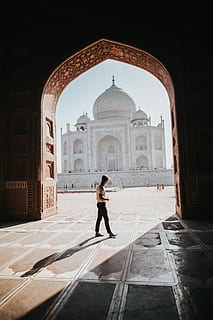 person standing inside building overlooking Taj Mahal at daytime, man walking while looking at taj mahal HD wallpaper