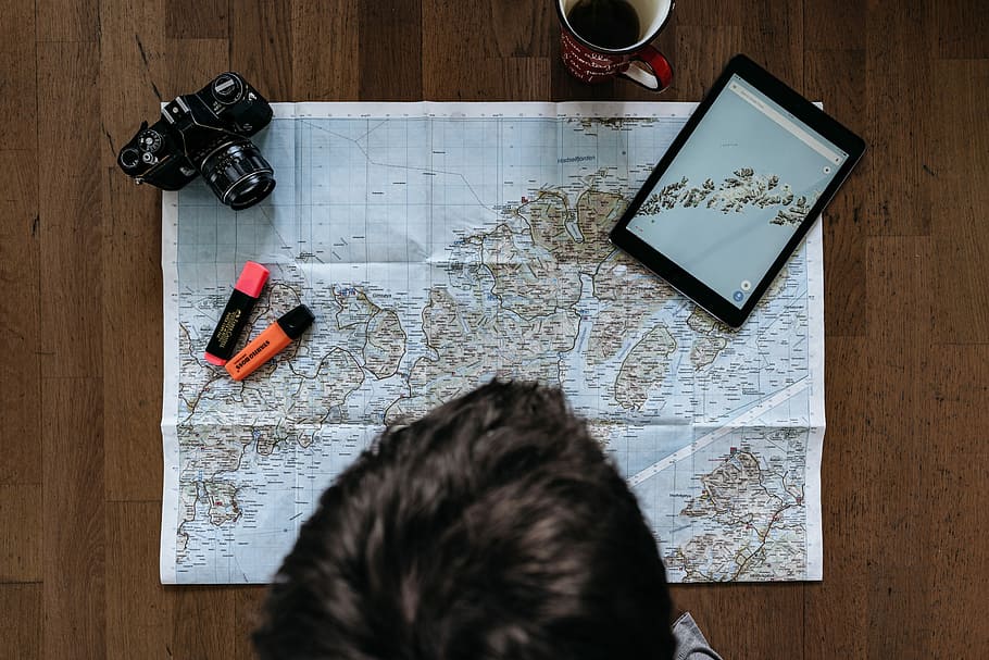 person looking at map on brown parquet floor, person facing on map, tablet, and marker HD wallpaper