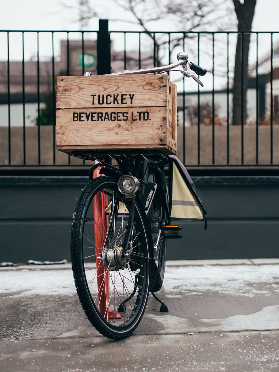 brown wooden box on top of bicycle parked near black railings HD wallpaper
