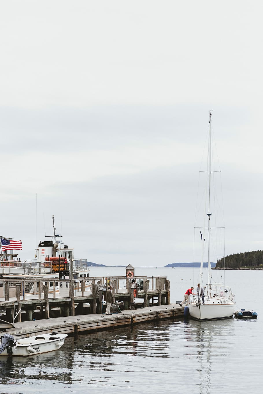 photo of a fishing vessel near on the concrete floor, man on white boat near wooden dock HD wallpaper