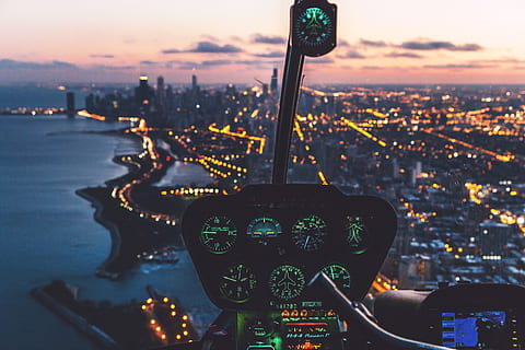 aerial view photography of helicopter cockpit and cityscape by water, aerial view of aircraft during nighttime HD wallpaper
