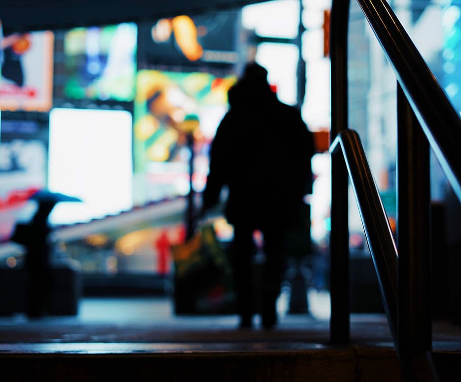 silhouette of person walking on street, silhouette photography of person walking near post and building with LED screens, HD wallpaper