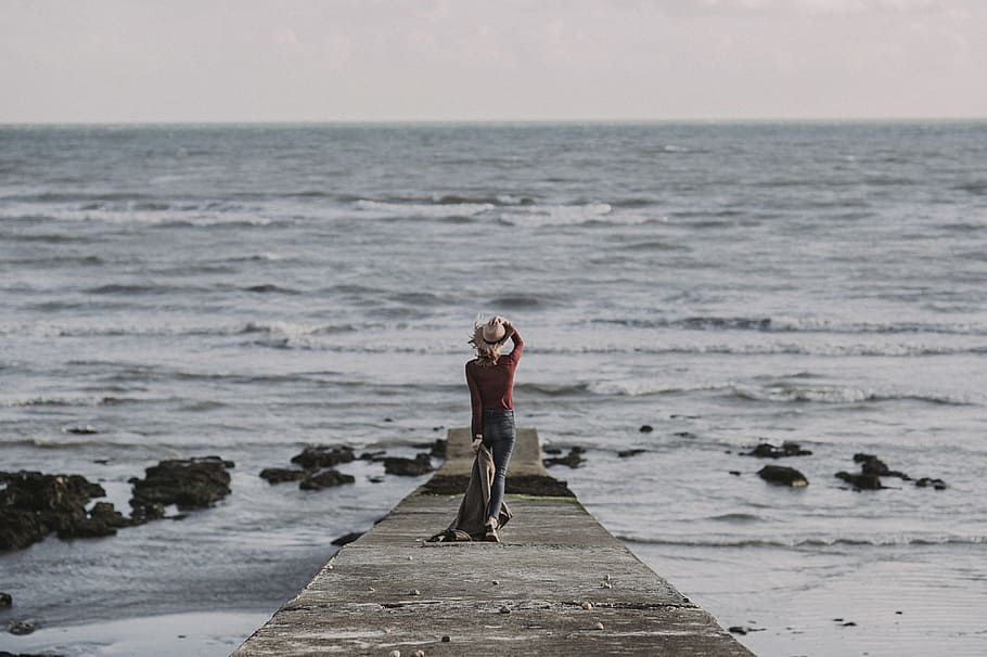 Person Standing on Dock Holding Textile, beach, coast, coat, concrete structure HD wallpaper