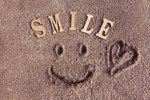 Smile cutaway decors on brown sand, text, single Word, sign, number HD wallpaper
