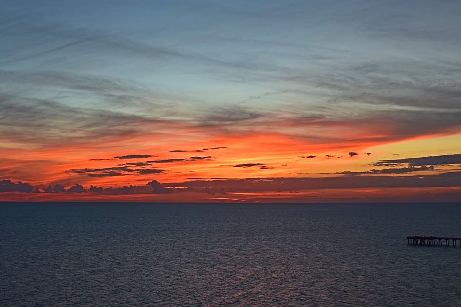 body of water under orange and white sky, calm water under golden hour HD wallpaper